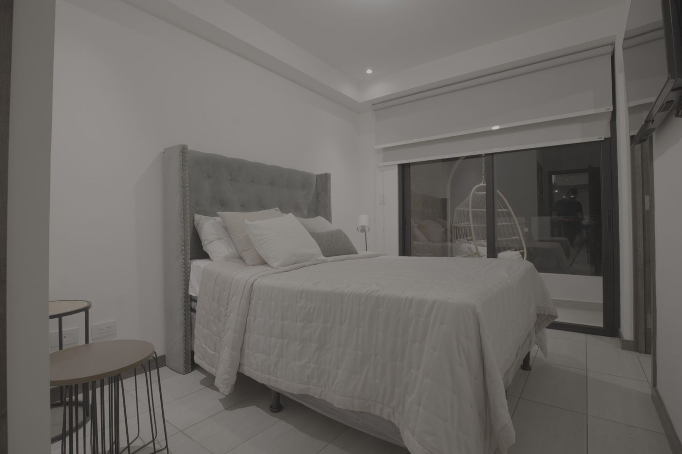 Flat unedited image: Primary bedroom with an upholstered headboard