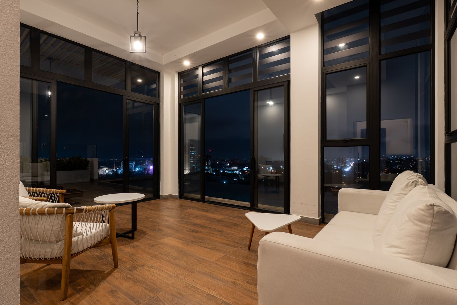 Rooftop lounge with a night view of the city