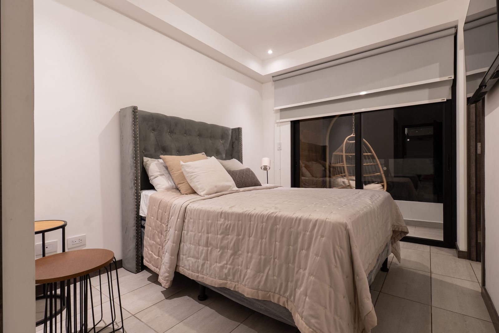 Primary bedroom with an upholstered headboard