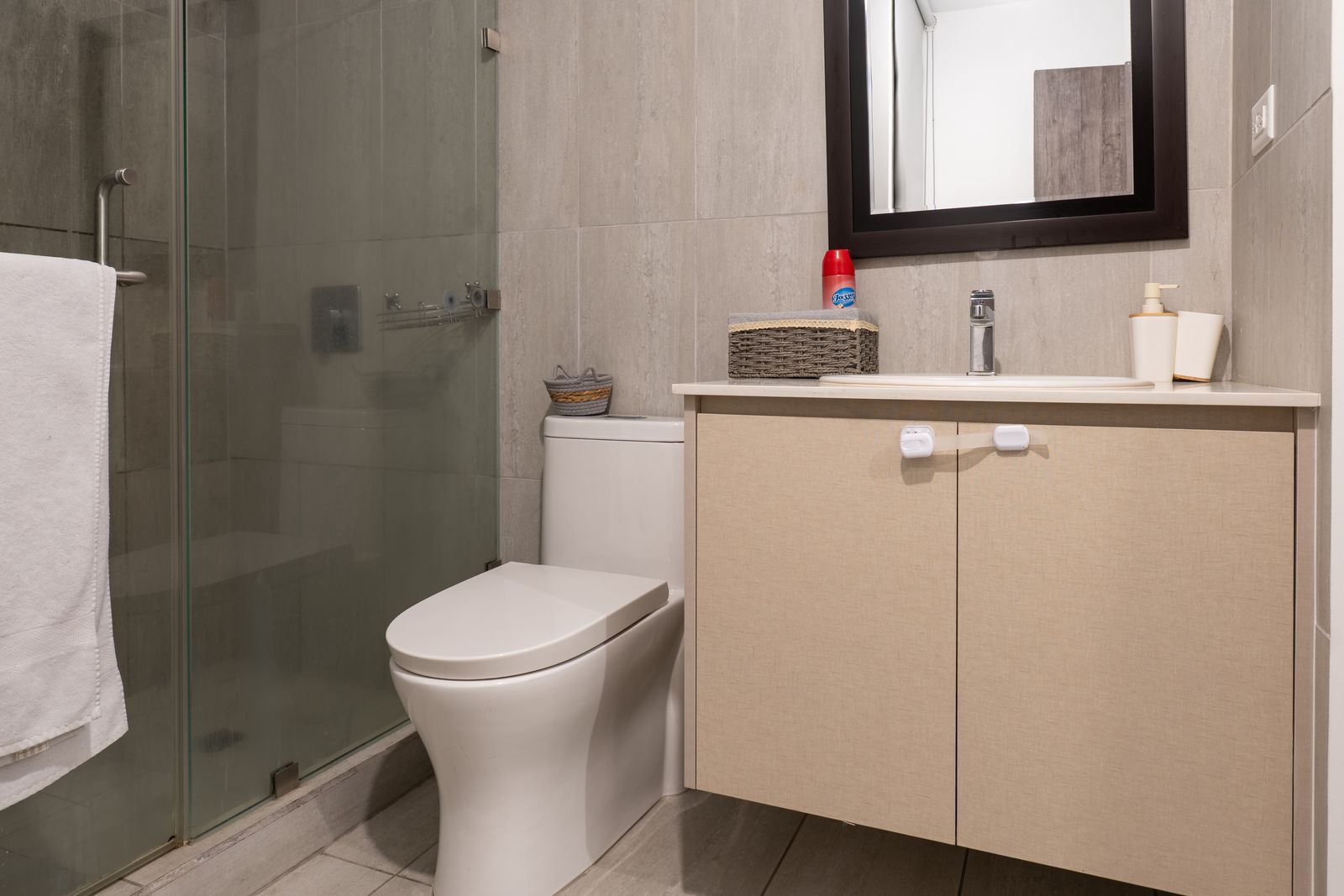 Bathroom with a glass shower and light vanity